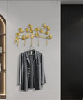 Heavy Duty Metal Wall Hooks For Living Room Decor And Bedroom Setup, gold plant design holding a hanging gray shirt.
