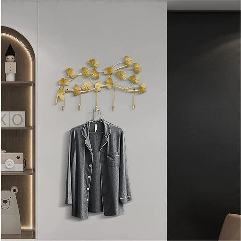 Heavy Duty Metal Wall Hooks For Living Room Decor And Bedroom Setup, gold plant design holding a hanging gray shirt.