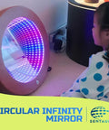 Child looking at Light Up 3D Circular Infinity Mirror With Color Changing Tunnel Lighting For Calming Sensory Stimulation In Classrooms And Clinics Multicolor Visual Illusion That Transforms Any Space.