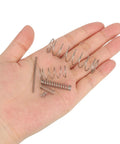 Front view: hand holding 10 uxcell stainless steel compression springs, 6 mm OD, 0.6 mm wire, 50 mm free length.