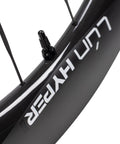 Close-up of Hyper 5 Road Bike Carbon Spoke Wheelset 700C rim, glossy black with white decal, hidden spoke design