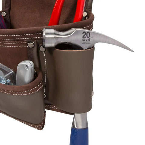Close-up of heavy duty leather tool apron with seven pockets, tool loops, hammer holder, and rivet reinforced edges for pro grade toughness.