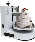 Smooth As Butter Automatic Cake Icing Smoother And No Fuss Cream Spreading Machine With Adjustable Stainless Steel Blades For Flawless Four To Fourteen Inch Frosting with three-tier cake and decorative flowers.