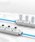 Built To Last Aluminum Air Manifold For Shop Use 3 Way 5 Port Pneumatic Block Splitter With One Quarter Inch NPT Output And One Half Inch NPT Supply Port For Industrial Workshop on white background with blue hoses attached