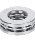 Close-up of a silver metal axial ball thrust bearing with visible inner race