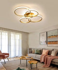 Modern 76W LED Chandelier Four Ring Flush Mount Ceiling Light illuminating a cozy living room with ambient cool white light.
