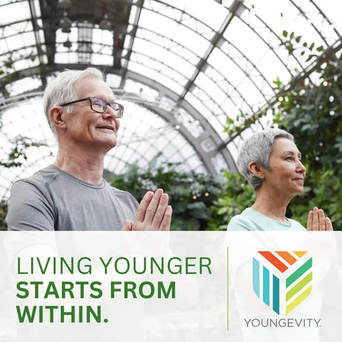 Two people practicing yoga in a greenhouse with a "Living Younger Starts From Within" banner and Youngevity logo.