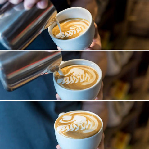 Barista using 350ml stainless steel frothing pitcher with mirror finish to create latte art, shown dripping milk into a cup.