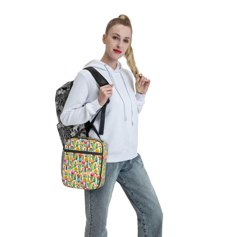 Person holding Desert Cactus Floral Insulated Lunch Tote for Office, Picnic and Camping with cactus print, lightweight design.