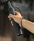 Hand holding Power Grip With Built In 5000mAh Battery For Action Cameras And Phones Wireless Control Selfie Stick in use