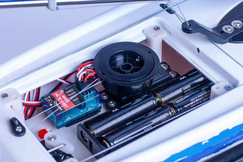 Inside view of Eclipse 650 Ready to Boat RC Sailboat With Dope Blow Molded ABS Hull showing wiring and battery compartment