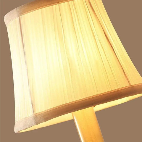 Close-up of modern brass wall lamp with white cotton drum shade matte warm antique finish easy install sconce for living room