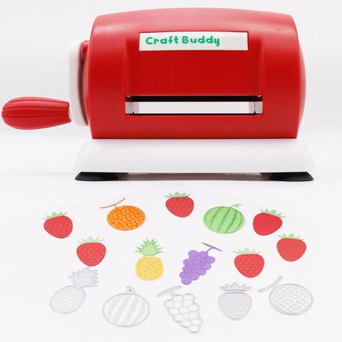 Red manual die cutting and embossing machine for DIY projects with fruit-shaped die cuts displayed in front.