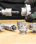 Hands assembling Small Arbor For Kwik Change Carbide Tipped Hole Cutter Fits Five Eighths To Two And A Quarter Inch Cutting Heads
