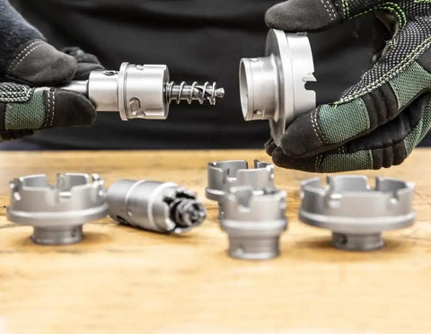 Hands assembling Small Arbor For Kwik Change Carbide Tipped Hole Cutter Fits Five Eighths To Two And A Quarter Inch Cutting Heads