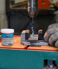 Pro Grade Pink Hard Paste Lubricant For MQL Precision Metalworking, Heavy Duty Synthetic Paste in workshop next to drill press