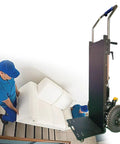 Heavy Duty Electric Stair Climbing Hand Truck Dolly With 1200W Motor Rips Up Steps And Hauls Massive Loads Easy Peasy For Pros And Handy Folks Moving Gear carrying a sofa up stairs.