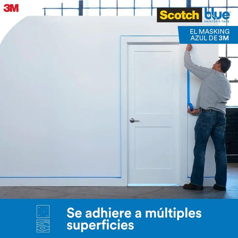 Man applying Blue Painters Tape For Multi Surface Use Easy Peel Damage Free Masking Tape on wall and door frame indoors