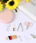 Heart Shaped Portable Travel Sewing Kit For On The Go Fixes Mini Box With Threads Scissors Hand Sewing Needles DIY Repair Tools Pink Compact Handy Essentials For Quick Mends displayed on a table with yellow flowers