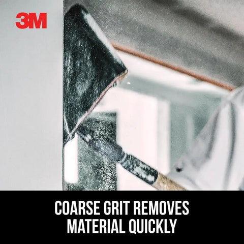 Worker using Pro-Pak Drywall Sanding Paper, 120 Grit to sand wall, highlighting coarse grit efficiency.