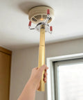 Leave The Ladder Behind With This Lightweight Aluminum Smoke Transducer Removal Tool Built For Quick Ceiling Detector Grabs and No Sweat Fire Safety Upgrades: user holding tool to remove ceiling smoke detector.