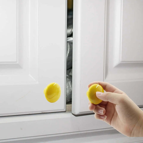 Top Shelf Handcrafted Ceramic Cabinet Knobs With A Slick Round Shape Designed To Kick Start Your Kitchen Drawer Dresser Desk Closet Or Bathroom Renovation Projects being held near a white cabinet.