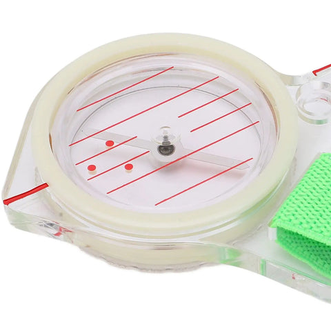 Close-up of Thumb Orienteering Compass with Luminous Glow for Easy One Hand Navigation, showing quick needle lock and carry loop.