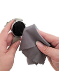 Gray microfiber cleaning cloth used to wipe a smartwatch screen