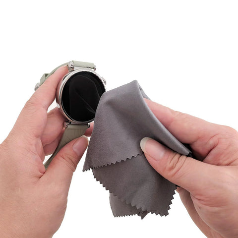 Xthel microfiber cleaning cloth, gray, close-up used to wipe a round smartwatch screen