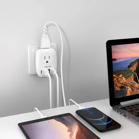 Six In One UK Travel Plug Adapter For US To UK Use Must Have Power Hub With Two Outlets Three USB Ports And One USB C Port International Power Converter For England Scotland Ireland London Hong Kong Up To 2500 Watts 250V 10A plugged into wall with devices connected.