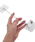 Hand holding Two Pack Childproof Fridge And Window Safety Locks for Cabinets with ABS and steel wire, no drill setup