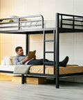 Straight Up Heavy Duty Twin XL Over Twin XL Metal Bunk Bed Built Tough With Secure Guardrails And Industrial Grade Steel For Adults Teens Or Kids Zero Creaking Black Frame Needs No Box Spring, man reading on lower bed.