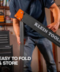 Tough As Nails Folding Sawhorses Heavy Metal Work Platform Non Skid Top Holds A Massive 1300 Lbs Each Rock Solid Rig For Carpenters And Contractors 2 Pack being handled by a person in a workshop.