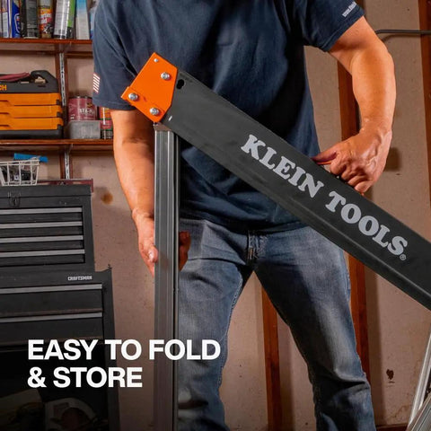 Tough As Nails Folding Sawhorses Heavy Metal Work Platform Non Skid Top Holds A Massive 1300 Lbs Each Rock Solid Rig For Carpenters And Contractors 2 Pack being handled by a person in a workshop.