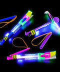 Cool LED Light Up Helicopters Slingshot Flying Toys Multicolor Pack Of 12 For Outdoor Play Bright LEDs That Fly Up To 100 Feet Easy To Use Totally Dope For Kids Party Favor For Backyard Fun displayed on black background