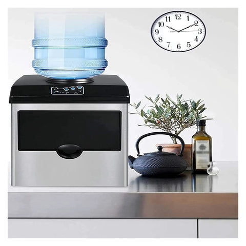 Top Tier Self Cleaning Countertop Ice Maker Portable Electric Machine with water jug on top and plant beside it.
