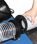 O'SKOOL 4-inch magnetic dust collector port fitting installed between a corrugated metal duct and gray flexible hose