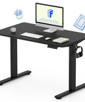 FLEXISPOT Electric Standing Desk With 40x24 Seamless One-Piece Black Desktop, ergonomic workstation, silent motor, and accessories.