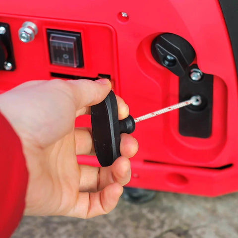 Hand pulling garage door pull rope with ergonomic plastic handle for emergency release; 39-inch rope for attic ladder access.