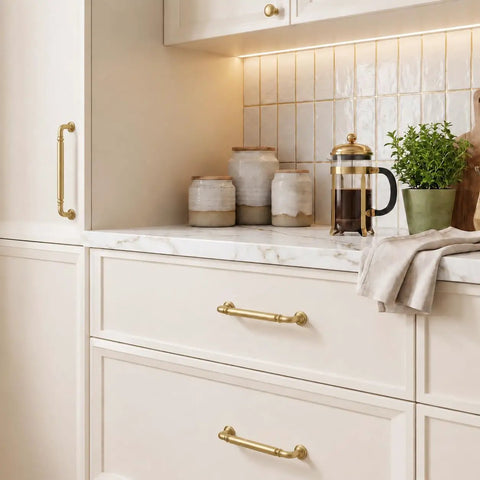 Image of 10-Pack Brushed Gold Cabinet Pulls 5-Inch Drawer Handles For Kitchen Digs Top-Shelf Zinc Alloy Hardware on white kitchen cabinets.