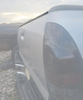 Side view of a Toyota Tacoma with a Tailgate Molding Cover Cap for 2005-2015, protecting the tailgate edge from scratches, made of durable plastic.