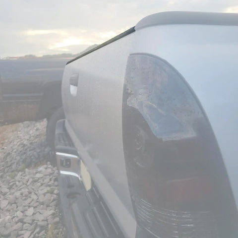 Side view of a Toyota Tacoma with a Tailgate Molding Cover Cap for 2005-2015, protecting the tailgate edge from scratches, made of durable plastic.