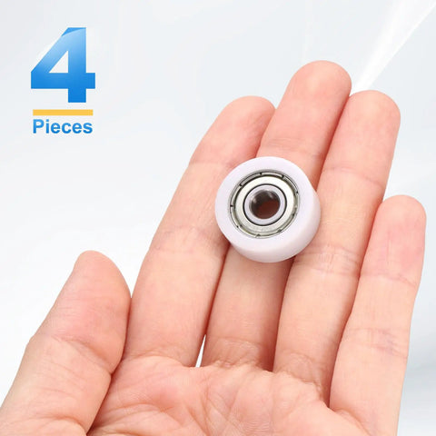 Holding a Four Pack Roller Idler Pulley 6x21x8mm with 606ZZ Bearings, white POM, in hand.