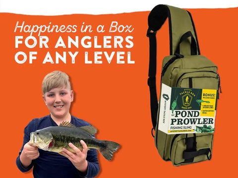 Boy holding fish beside Mystery Tackle Box Pond Prowler Sling Fishing Lure Kit Green Sling Pack With Bonus Multispecies Bait
