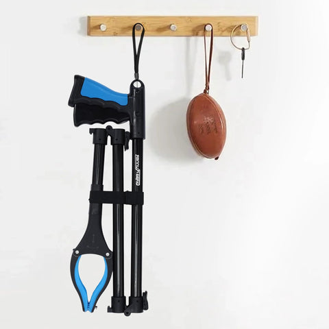 Two GrabRunner extra-long grabber reachers, blue/black, extendable 38–44 in, hanging on wall rack