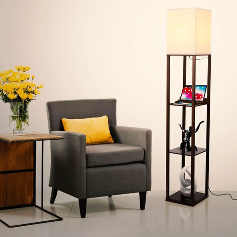 Maxwell Charger Shelf Floor Lamp With USB Ports And Electrical Outlet in Havana Brown beside armchair and side table with flowers