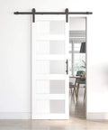 Sliding Glass Barn Door 30x84 Inches With 5 Ft Hardware Kit And Handle Included, 5-Panel Frosted Glass, Solid Wood Wrapped In White Waterproof PVC Surface, Pre-Drilled Holes For Easy Assembly, Sleek Modern Durable Rustic Style installed view in living room.