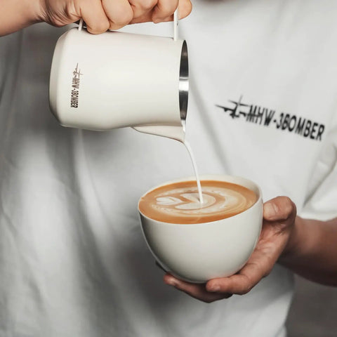 Milk Frothing Pitcher 12oz 350ml Stainless Steel For Espresso And Latte Art, Round Spout Milk Jug, White Finish, pouring into cup