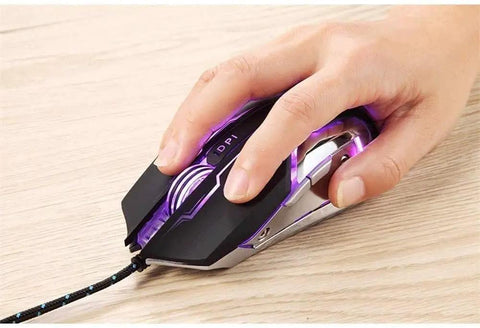 Top Tier Gaming Keyboard And Mouse Combo Featuring Colorful Breathing RGB Backlights And High Response Mouse with a hand gripping the mouse.