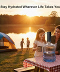 Family using Electric USB Charged Water Dispenser Pump For 2 To 6 Gallon Bottles at campsite during sunset.